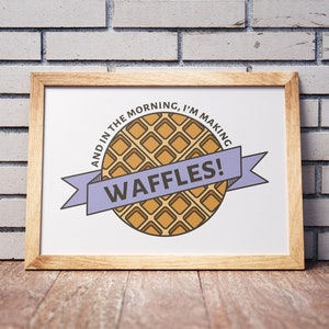May include: A framed print with a cartoon waffle and the text "And in the morning, I'm making waffles!"