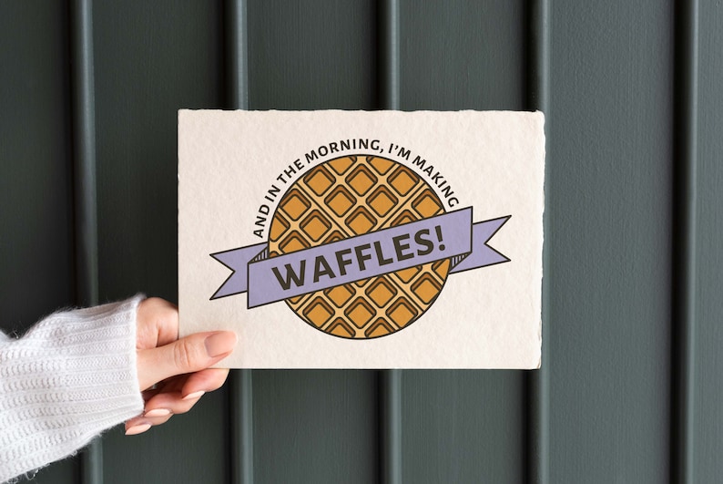May include: A white card with the text "And in the morning, I'm making waffles!" and a cartoon illustration of a waffle. The text is in a purple banner.