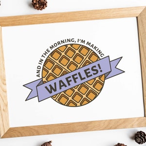 May include: A framed print with a cartoon illustration of a waffle and the text "And in the morning, I'm making waffles!"
