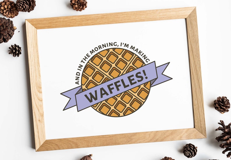 May include: A framed print with a cartoon illustration of a waffle and the text "And in the morning, I'm making waffles!"
