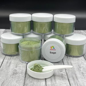 May include: Eight small jars of green mica powder, stacked in a pyramid shape. The jars have white lids and are labeled "Sage".