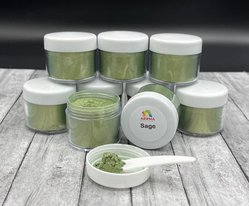 May include: Eight small jars of green mica powder, stacked in a pyramid shape. The jars have white lids and are labeled "Sage".