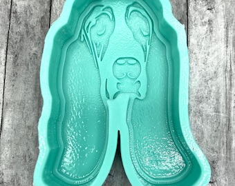 May include: A light green silicone mold shaped like a Bloodhound dog. The mold is designed to create a 3D replica of a Bloodhound dog.