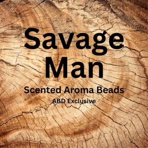 May include: A close-up of a wooden surface with the text "Savage Man Scented Aroma Beads ABD Exclusive" in black lettering.