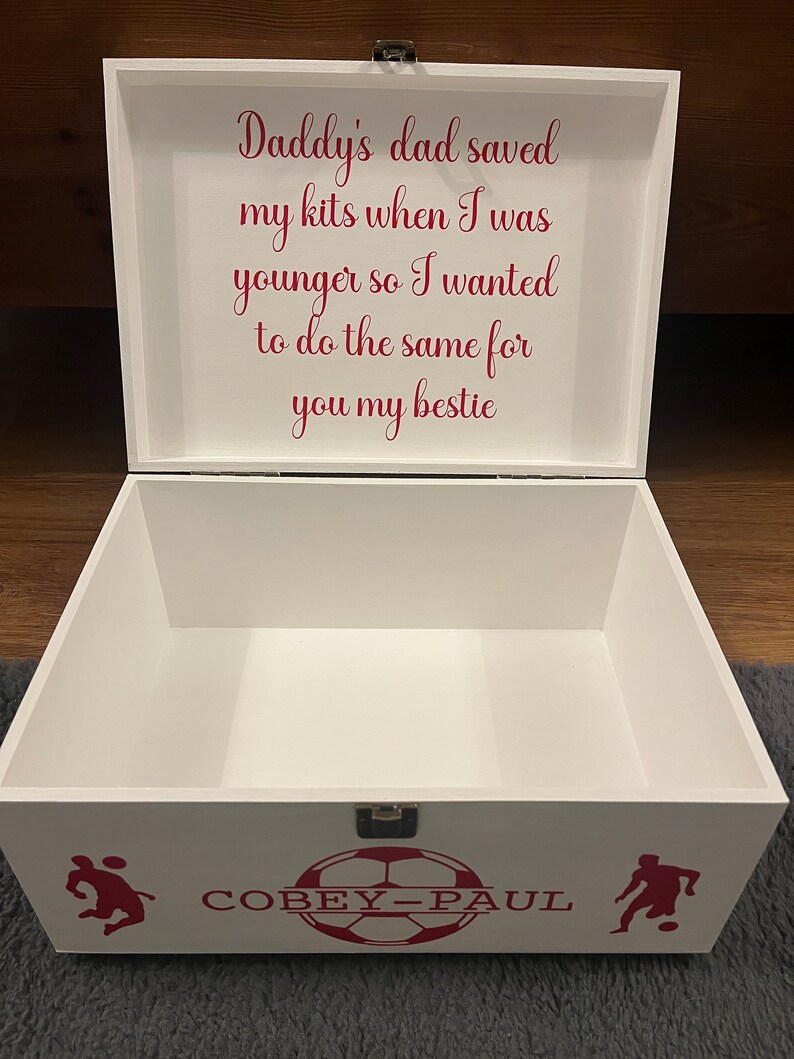 May include: White wooden box with a red inscription that reads "Daddy's dad saved my kits when I was younger so I wanted to do the same for you my bestie". The box has a red soccer ball design with the name "COBEY-PAUL" written on it.