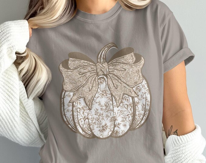 Vintage pumpkin graphic tee with floral bow, fall coquette aesthetic, farmhouse chic, autumn casual wear, rustic cottagecore inspired shirt