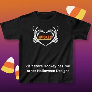 May include: Black t-shirt with a skeleton hand heart design and the word "HOCKEY" inside the heart. The text "Visit store HockeyIceTime other Halloween Designs" is at the bottom of the shirt.