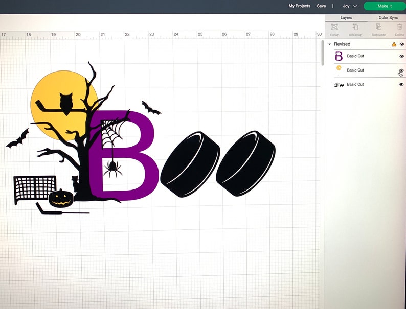 May include: A purple letter "B" with a spider and web hanging from it. A black silhouette of a tree with an owl perched on a branch. A yellow moon behind the tree. Two black hockey pucks. A black silhouette of a hockey net and a pumpkin. The text "Boo" is written in black.