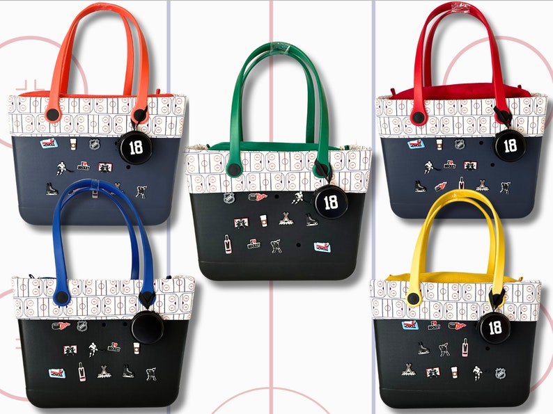 May include: Five tote bags with different colored handles. Each bag has a white and black patterned design with hockey-themed graphics and a black circle with the number "18" on it.