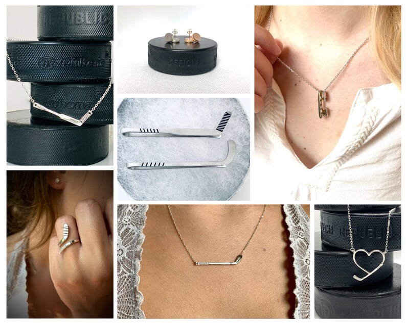 May include: A set of hockey-themed jewelry, including a necklace with a hockey stick pendant, a ring with a hockey stick design, and a pair of earrings with hockey puck designs. The jewelry is displayed on a black hockey puck.