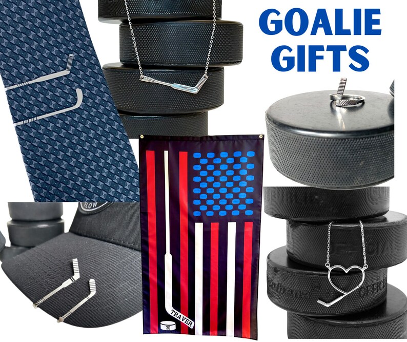May include: A collection of goalie gifts featuring hockey stick and puck designs. The gifts include a tie bar, a necklace, a hat, a flag, and a puck. The flag is an American flag with a hockey stick design. The text "GOALIE GIFTS" is displayed in blue letters.