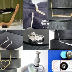 May include: A collection of hockey-themed items, including a wooden wine bottle holder shaped like a hockey stick, silver hockey stick tie clips, gold and silver hockey stick necklaces, a silver ring, and a hockey puck bottle stopper.