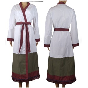 May include: White robe with long sleeves, a burgundy belt, and trim. The robe has a V-neck and a color block design with a green lower section. The hemline features a burgundy border with fringe.