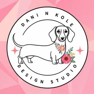 May include: A circular logo featuring a black and white line drawing of a dachshund dog with a floral arrangement around its neck. The text DANI N KOLE DESIGN STUDIO is printed in black along the inner border, with two small pink four-pointed stars.