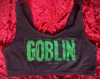 May include: Black sports bra with a green "GOBLIN" graphic print.