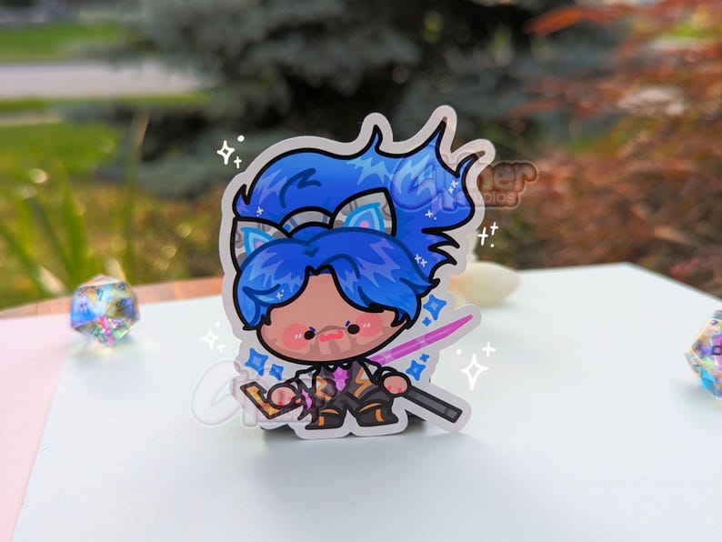 May include: A blue and white anime character sticker with a pink sword and sparkles. The character has blue hair and a white headband with cat ears.
