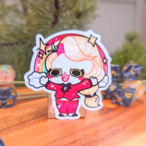 May include: A white cartoon character with pink cheeks and a red jacket with a black bow tie. The character has blonde hair and is standing in front of a rainbow with stars. The character is smiling and has a happy expression.