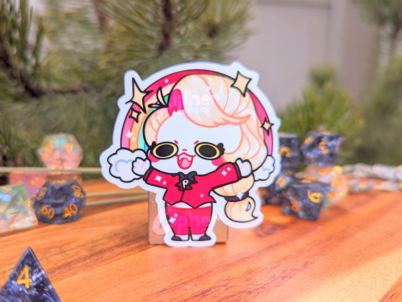 May include: A white cartoon character with pink cheeks and a red jacket with a black bow tie. The character has blonde hair and is standing in front of a rainbow with stars. The character is smiling and has a happy expression.
