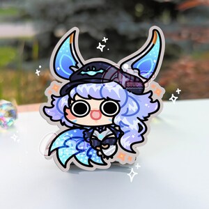 May include: A blue and purple anime character with a black hat and blue wings. The character has large eyes and a surprised expression. The background is white with stars.