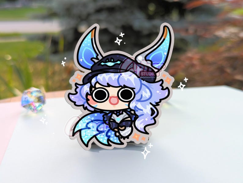 May include: A blue and purple anime character with a black hat and blue wings. The character has large eyes and a surprised expression. The background is white with stars.