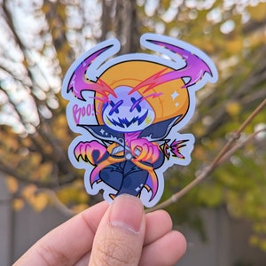 May include: A sticker featuring a cartoon character with a pumpkin head, wearing a black and purple costume. The character has a wide grin and X-shaped eyes. The sticker has a white background and the word "Boo!" is written in pink letters.