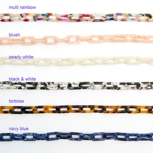 May include: Six different colours of plastic chain links, including multi rainbow, blush, pearly white, black and white, tortoise, and navy blue.