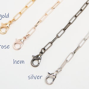 Könnte beinhalten: Drei Kettenverlängerungen in Gold, Roségold und Silber. Jede Verlängerung hat einen Karabinerverschluss.