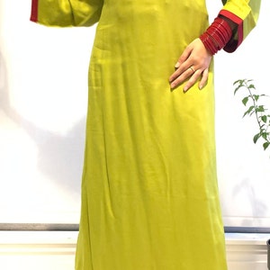 May include: A lime green long-sleeved kurta with red trim and gold embroidery. The kurta is paired with maroon palazzo pants. The model is wearing silver heels.