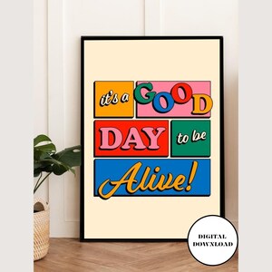 May include: A colorful digital print with the text "it's a GOOD DAY to be Alive!" in a retro style. The words are in different colored boxes.