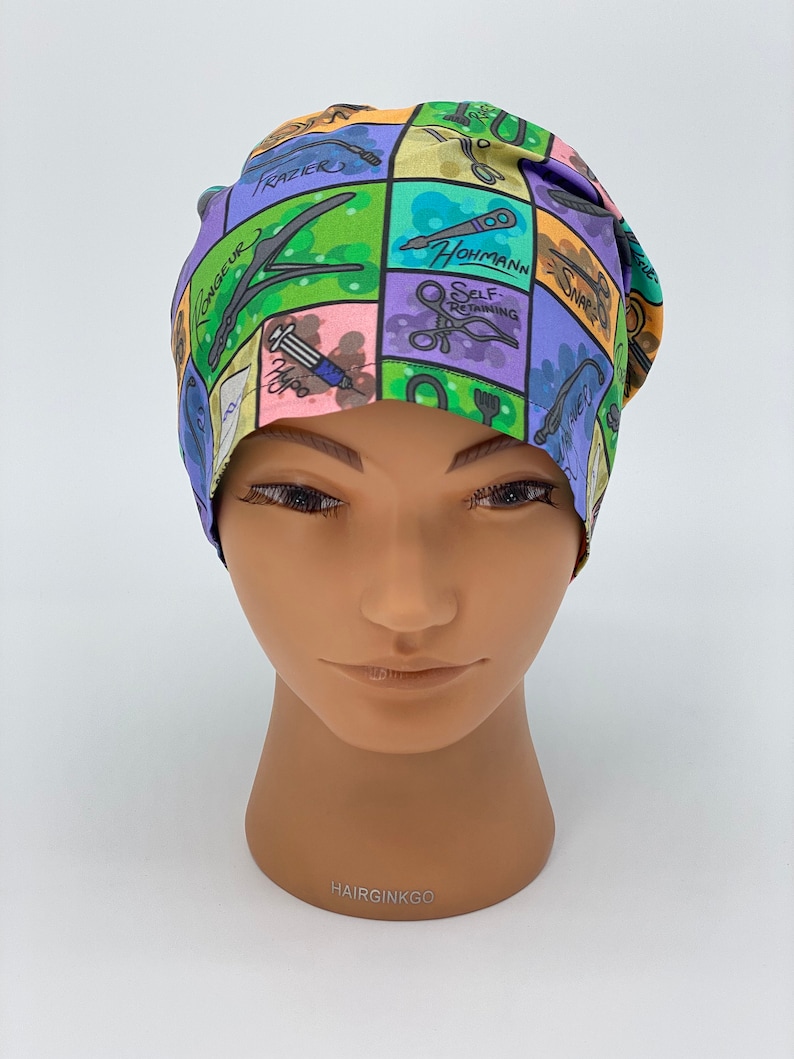 May include: A colorful surgical scrub hat with a variety of surgical instruments and tools printed on it. The hat is made of a soft, breathable fabric and is designed to be comfortable to wear for long hours.