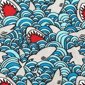May include: A repeating pattern of cartoon sharks and ocean waves. The sharks are white with red mouths and sharp teeth. The waves are blue and white, creating a dynamic and playful design.