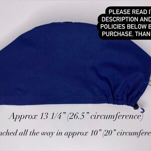 May include: A navy blue surgical scrub cap. The cap is approximately 6 inches high and 13 1/4 inches (26.5 cm circumference) around. The cinched circumference is approximately 10 inches (20 cm). The text on the image says "PLEASE READ ITEM DESCRIPTION AND SHOP POLICIES BELOW BEFORE PURCHASE. THANK YOU!"