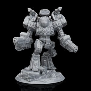 May include: A grey miniature robot figurine with intricate detailing. The robot features two large guns, a rounded helmet, and stands on a rocky base. The background is black.