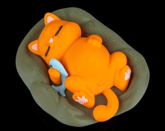 Sleeping Cat Figure – Orange Cat Curled Up in Green Bed