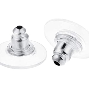 May include: Two silver earring backs with clear plastic backing. The backs are designed to be used with post earrings.