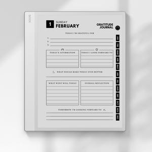 May include: A digital gratitude journal displayed on a white tablet. The screen shows a daily layout with prompts for reflection, including sections for affirmations, gratitude, and future goals. The journal is dated Sunday, February 1st.