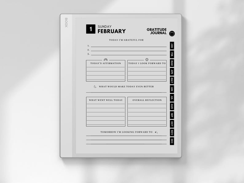 May include: A digital gratitude journal displayed on a white tablet. The screen shows a daily layout with prompts for reflection, including sections for affirmations, gratitude, and future goals. The journal is dated Sunday, February 1st.