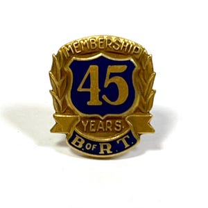 May include: Gold-colored pin with a blue shield featuring the number 45 and the text "MEMBERSHIP 45 YEARS B. of R.T."