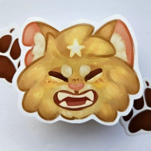 May include: A sticker featuring a cartoon lion with a star on its head, showing its teeth. The lion is primarily gold with pink accents. Two brown paw print stickers are also included.