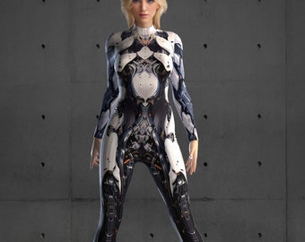 May include: A woman wearing a white and black jumpsuit with a futuristic design. The jumpsuit has a high neckline and long sleeves. The woman is standing in front of a gray concrete wall.