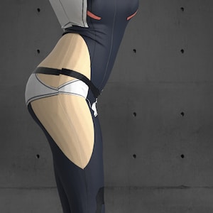 May include: A woman wearing a black and white jumpsuit with red accents. The jumpsuit has a white belt and a white panel on the back. The woman is standing in front of a gray concrete wall.