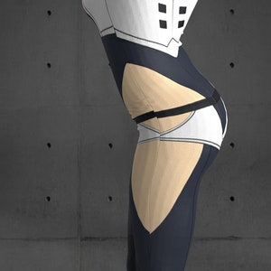 May include: A black and white bodysuit with a beige panel on the leg. The bodysuit has a white panel with black squares on the chest and a black belt around the waist.