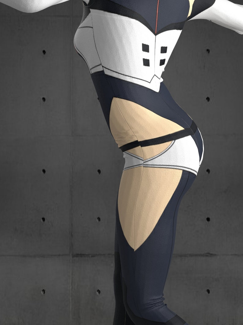 May include: A black and white bodysuit with a beige panel on the leg. The bodysuit has a white panel with black squares on the chest and a black belt around the waist.