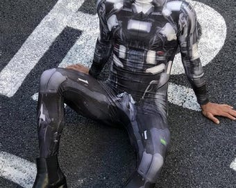 May include: A long-sleeved, full-length bodysuit featuring a high neck and a printed graphic design of metallic, mechanical armor plates in shades of black, gray, and white, paired with black leather ankle boots with a block heel.