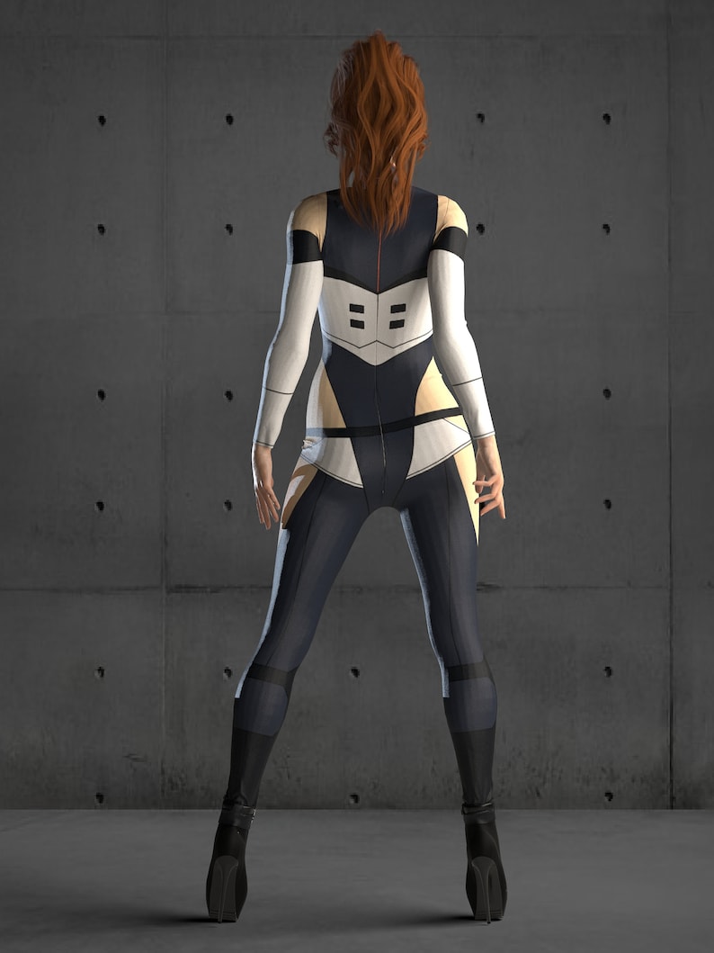 May include: A woman wearing a black and white jumpsuit with a red stripe down the back. She is standing in front of a concrete wall.