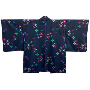 May include: A black Japanese Hanten jacket with a colorful floral pattern. The jacket has a traditional design and is made of a soft, comfortable fabric.