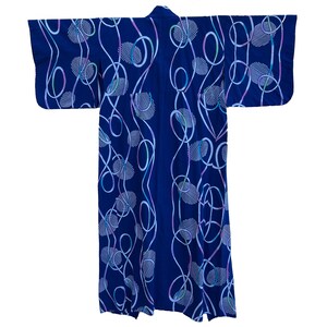 May include: A blue kimono with a white and pink abstract pattern of circles and lines.