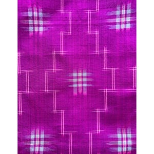 May include: A purple fabric with a white geometric pattern. The pattern is made up of squares and rectangles.