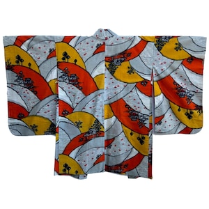 May include: A traditional Japanese kimono with a colorful pattern of orange, yellow, and gray hills and houses. The kimono is made of a lightweight fabric and has a relaxed fit.