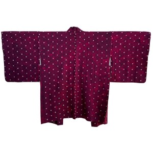May include: A burgundy kimono with a white polka dot pattern. The kimono is made of a soft, lightweight fabric and has a traditional Japanese design.